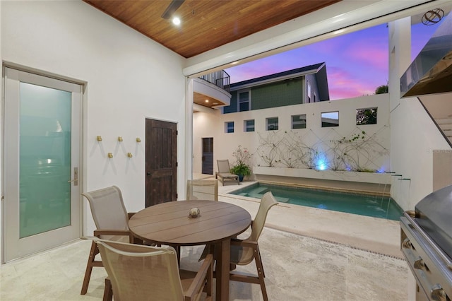 interior space with outdoor dining space and a fenced in pool