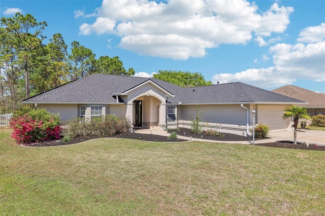 ranch-style home with a front yard, concrete driveway, a garage, and stucco siding