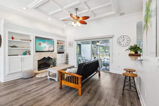 living room with a fireplace with raised hearth, coffered ceiling, dark wood-style floors, baseboards, and ceiling fan