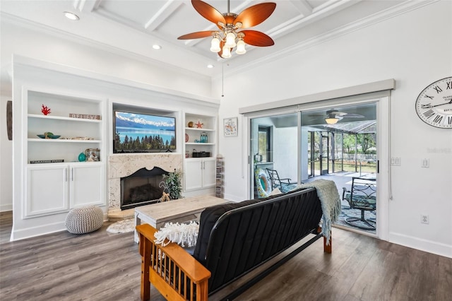 living area featuring wood finished floors, coffered ceiling, and ceiling fan