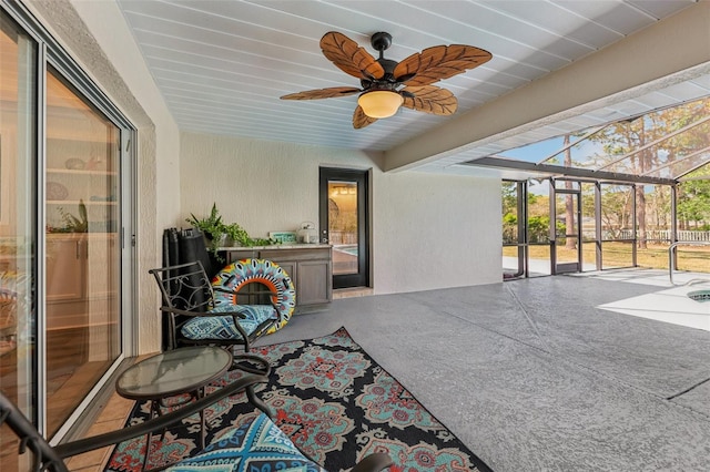 sunroom / solarium with a ceiling fan