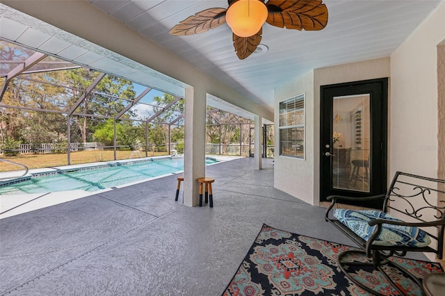 outdoor pool featuring a patio, a ceiling fan, and a lanai