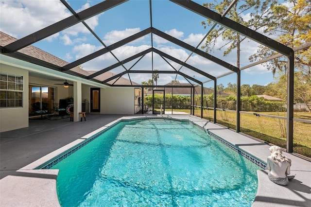 pool featuring a lanai, a ceiling fan, and a patio area