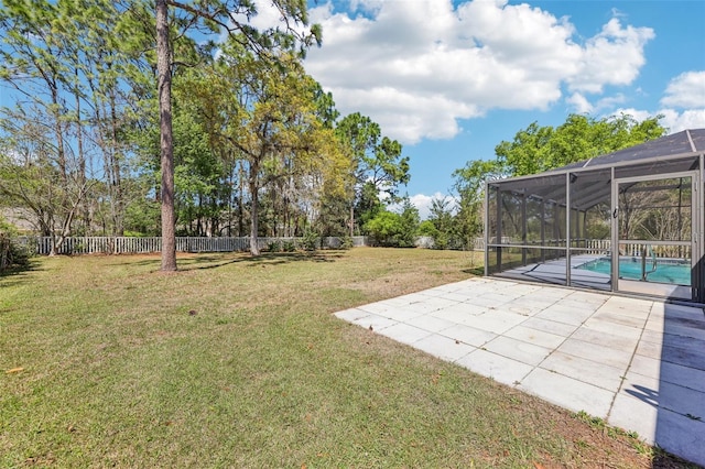 view of yard with a patio area, a fenced in pool, glass enclosure, and fence