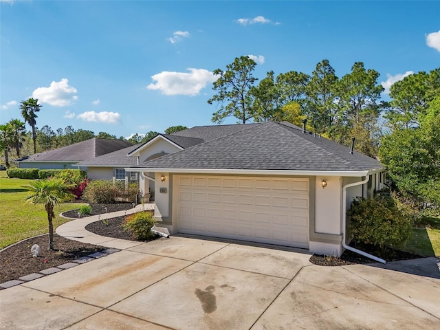 ranch-style home featuring concrete driveway, a garage, roof with shingles, and stucco siding