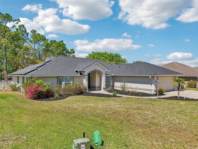 ranch-style home with a shingled roof, a front lawn, concrete driveway, stucco siding, and a garage