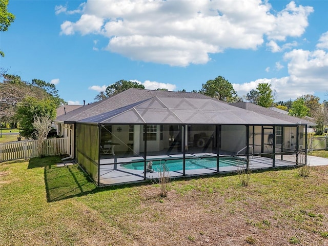 view of swimming pool featuring a yard, a patio, a lanai, and a fenced backyard