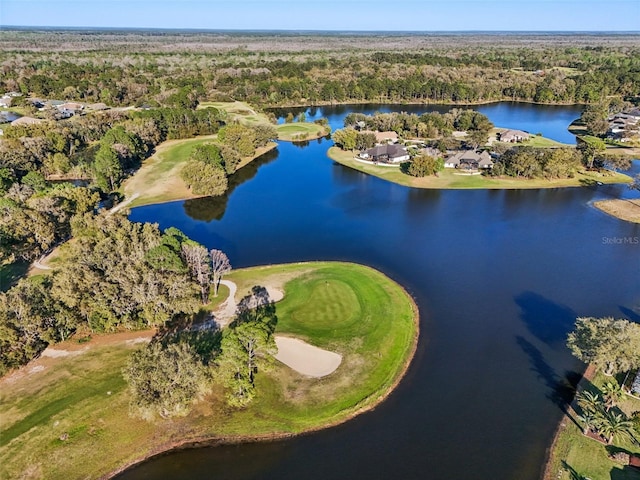 birds eye view of property with golf course view, a wooded view, and a water view