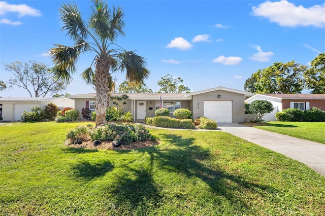 ranch-style house with stucco siding, an attached garage, concrete driveway, and a front yard