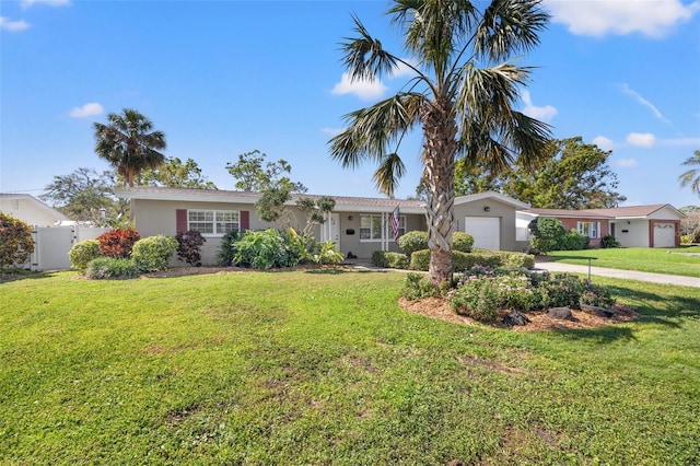 ranch-style house with fence, stucco siding, concrete driveway, a front lawn, and a garage