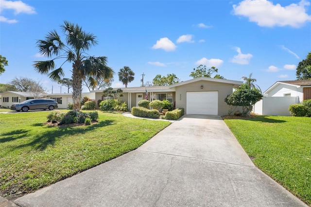 ranch-style house with stucco siding, driveway, fence, a front yard, and a garage