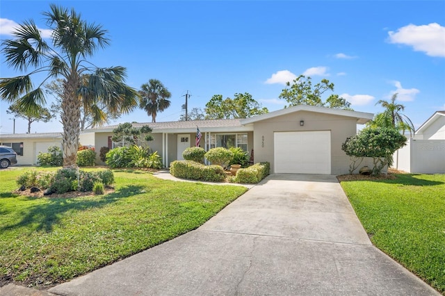 single story home featuring a garage, concrete driveway, a front lawn, and stucco siding