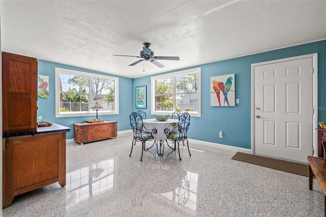 dining area with speckled floor, baseboards, a textured ceiling, and ceiling fan