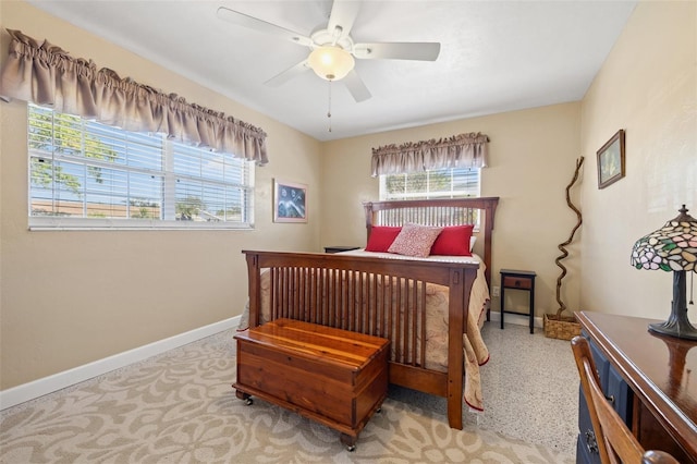 bedroom with ceiling fan and baseboards