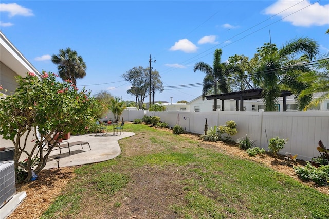 view of yard featuring central AC unit, a patio area, and a fenced backyard