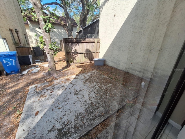 exterior space with stucco siding and fence