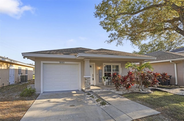 view of front facade with driveway, a porch, an attached garage, central AC, and stucco siding