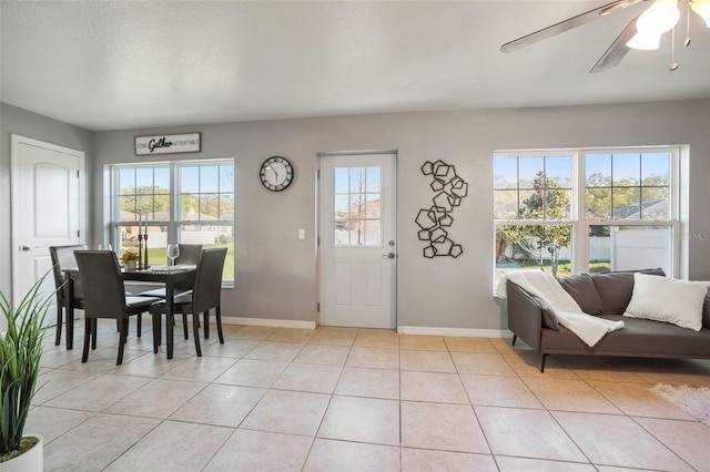 entryway featuring light tile patterned floors, baseboards, and a ceiling fan