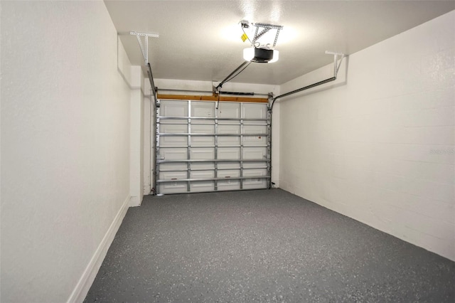 garage featuring a garage door opener and baseboards