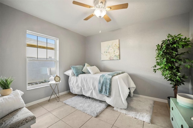 bedroom featuring light tile patterned floors, ceiling fan, and baseboards