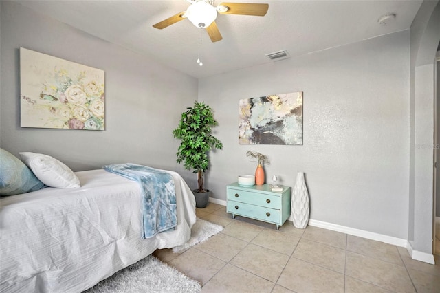 bedroom with visible vents, baseboards, ceiling fan, and tile patterned flooring