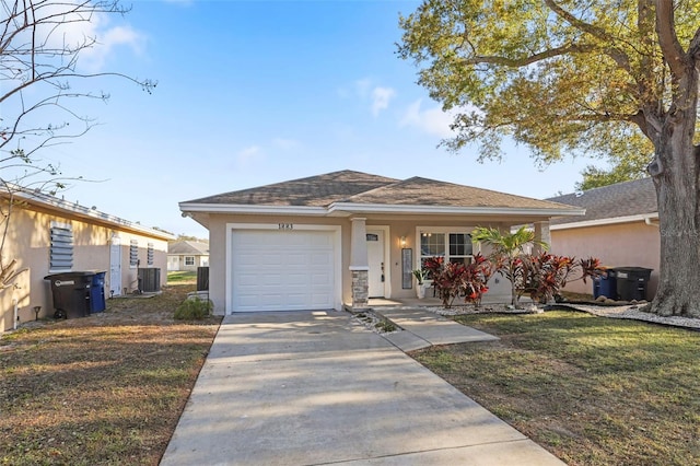 view of front of house with a front yard, central AC unit, an attached garage, stucco siding, and concrete driveway