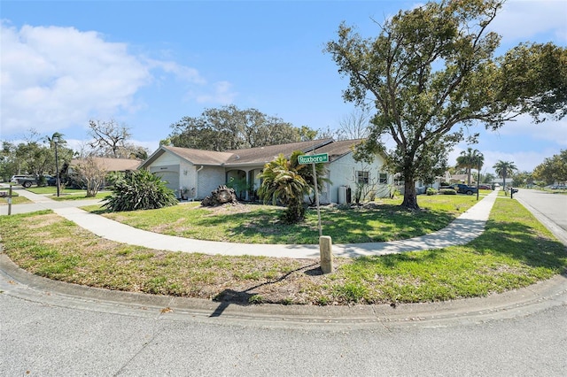 view of front of house featuring an attached garage and a front yard