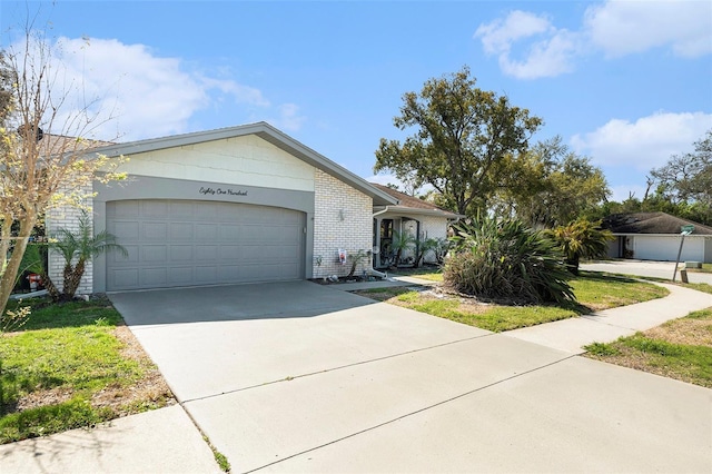 single story home with an attached garage, brick siding, and driveway