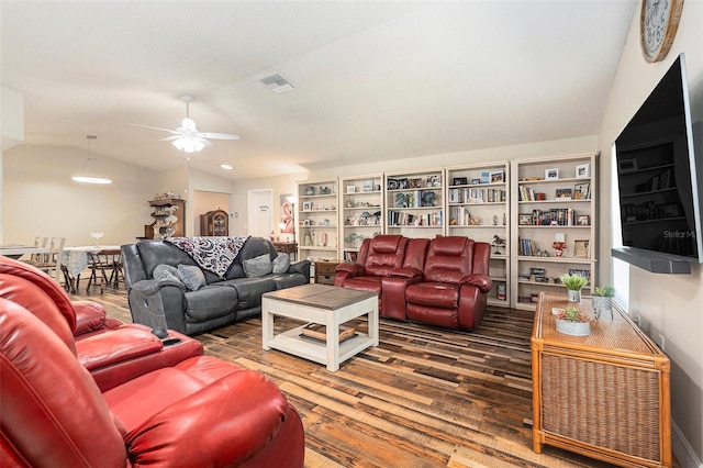 living area featuring visible vents, lofted ceiling, wood finished floors, and a ceiling fan