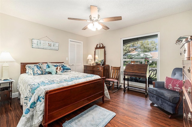 bedroom with ceiling fan, dark wood-type flooring, a closet, and a textured ceiling