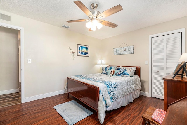 bedroom featuring visible vents, baseboards, and wood finished floors