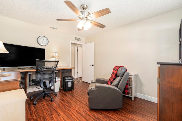 office with a ceiling fan, wood finished floors, and visible vents