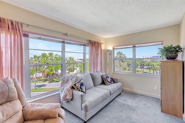 carpeted living room featuring a textured ceiling and baseboards