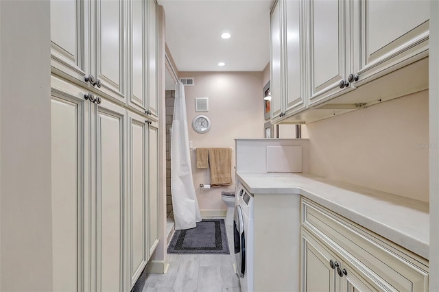 laundry room with cabinet space, visible vents, washer and dryer, and recessed lighting