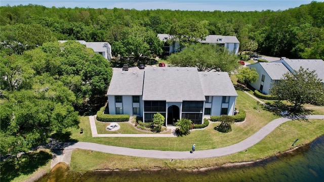 birds eye view of property with a forest view