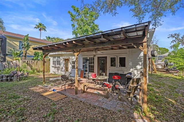 rear view of house with a patio and fence