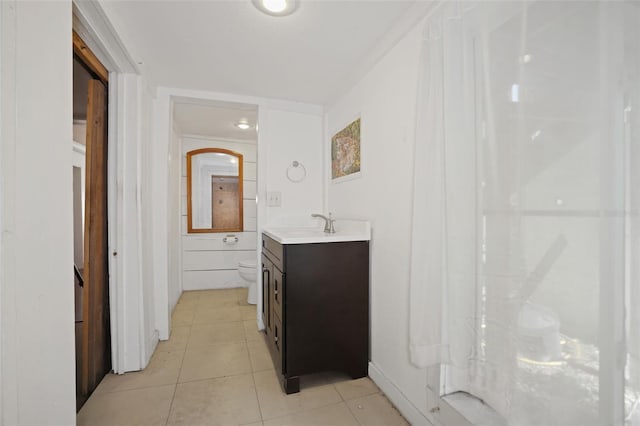 bathroom with vanity, tile patterned floors, and toilet