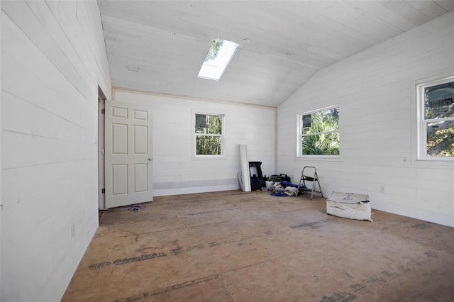 interior space featuring lofted ceiling with skylight