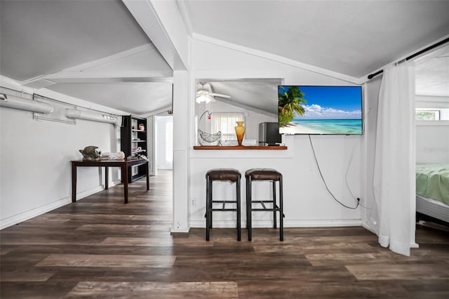 interior space featuring vaulted ceiling, wood finished floors, baseboards, and ceiling fan