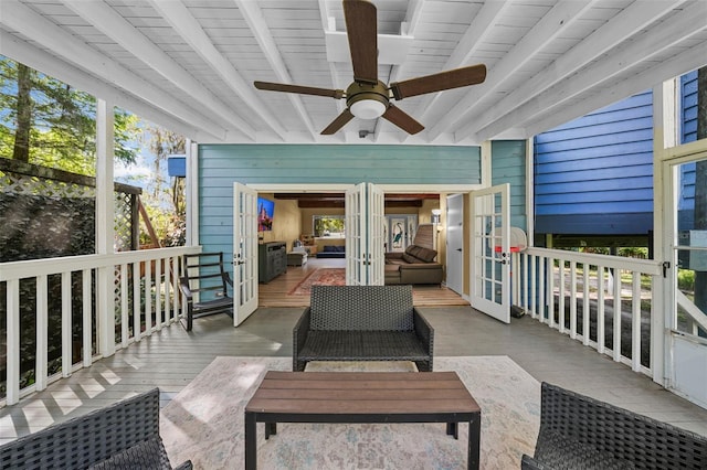 exterior space with beamed ceiling, plenty of natural light, a ceiling fan, and french doors