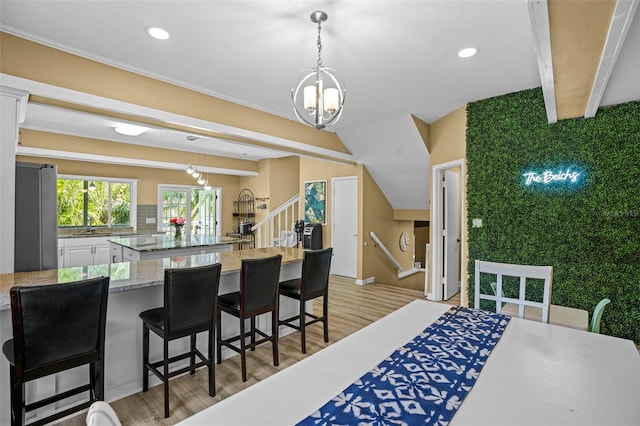 dining space featuring beamed ceiling, recessed lighting, stairway, and light wood-style floors