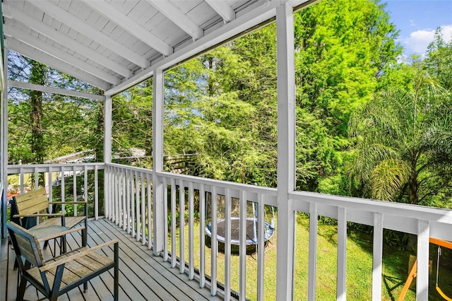 wooden deck featuring a lawn