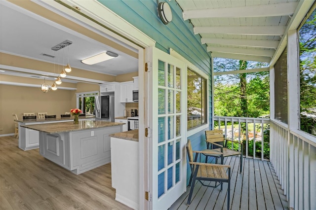 deck with visible vents and outdoor dry bar