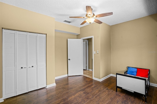 sitting room with wood finished floors, visible vents, baseboards, ceiling fan, and a textured ceiling