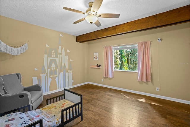 bedroom with ceiling fan, baseboards, beamed ceiling, hardwood / wood-style flooring, and a textured ceiling