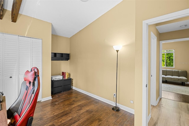 home office with vaulted ceiling, wood finished floors, and baseboards