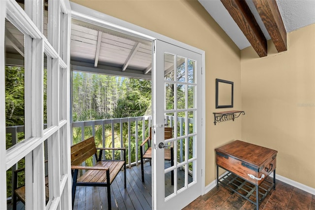 doorway to outside featuring french doors, lofted ceiling with beams, baseboards, and dark wood-style flooring