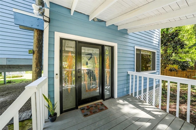 doorway to property featuring fence