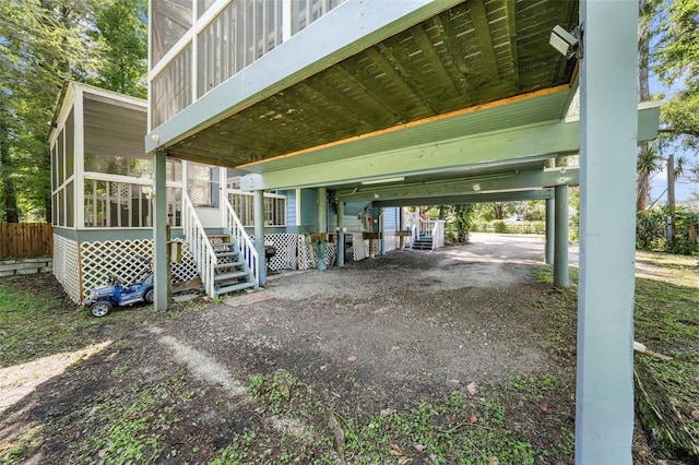 view of side of home with a carport and a sunroom