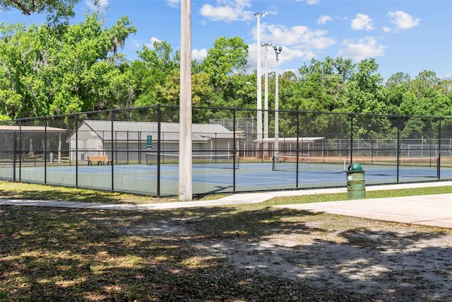 view of sport court featuring fence